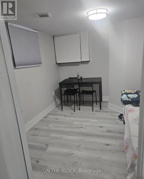 Toronto (Eglinton East) apartment for rent - A small room with a desk and chairs.