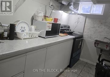 Toronto (Eglinton East) apartment for rent - A kitchen counter with a white fridge and a black dishwasher.