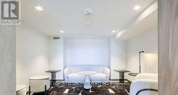 Hamilton (Beasley) condo for rent - A well-lit, modern bedroom with a large bed and a small table.
