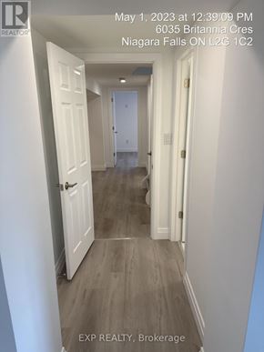 Niagara Falls (Hospital) apartment for rent - A hallway with white doors and grey flooring.