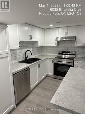 Niagara Falls (Hospital) apartment for rent - A kitchen with white cabinets and a marble countertop.