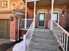 Pickering (Woodlands) townhouse for rent - A house with a porch and a green door.