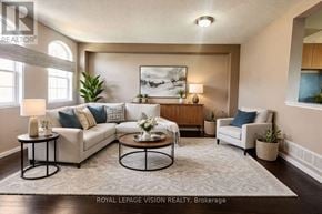 Pickering (Woodlands) townhouse for rent - A well-lit living room with a large painting on the wall and a comfortable seating area.