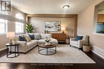 Pickering (Woodlands) townhouse for rent - A well-lit living room with a large painting on the wall and a comfortable seating area.