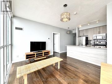Mississauga (City Centre) condo for rent - A modern living room with a wooden floor and a television on a wooden stand.