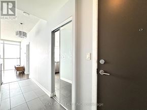 Mississauga (City Centre) condo for rent - A glass door with a handle and a wall on the other side.