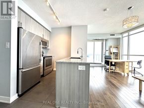 Mississauga (City Centre) condo for rent - A kitchen with a refrigerator, microwave, and oven.