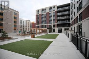 London East (East K) apartment for rent - A view of a courtyard with a fence and a building in the background.