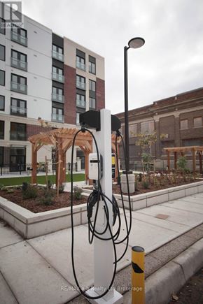 London East (East K) apartment for rent - A charging station for electric vehicles is located on a sidewalk.