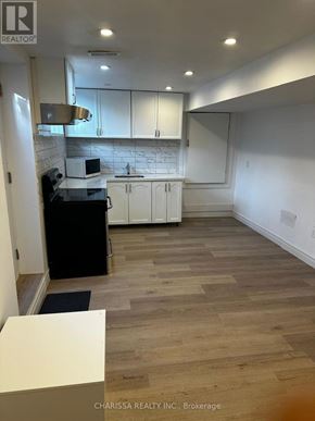 Clarington (Bowmanville) apartment for rent - A kitchen with white cabinets and a marble backsplash.