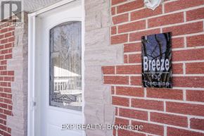 Cobourg apartment for rent - A sign on a brick wall that says Breeze 130 Tremaine.