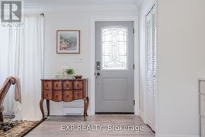 Cobourg apartment for rent - A room with a wooden table and a framed picture on the wall.