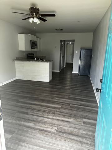 Warner Robins apartment for rent - A kitchen with a white counter and a ceiling fan.