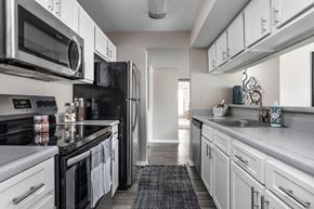 Cordova townhouse for rent - Renovated, galley kitchen with stainless steel appliances and white cabinets
