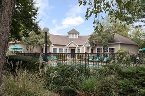 Cordova townhouse for rent - Exterior of apartment clubhouse with lounge chairs and gated swimming pool