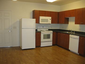 Phoenix apartment for rent - a kitchen with white appliances and wooden cabinets