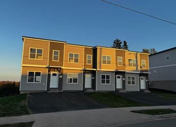 Dartmouth apartment for rent - A row of houses with a clear blue sky above them.