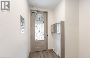 Hamilton apartment for rent - A hallway with a door and a sign on the wall.