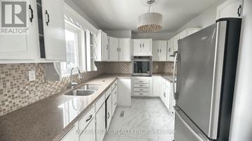 Toronto (Dorset Park) apartment for rent - A kitchen with a refrigerator, sink, and cabinets.