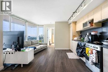 Vancouver apartment for rent - A modern kitchen with a dining area and a living room.
