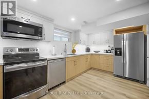 Mississauga (Streetsville) condo for rent - A modern kitchen with stainless steel appliances and wooden cabinets.
