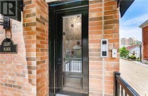 Hamilton (Landsdale) multi-family for rent - A brick building with a black door and a sign that says "Grant Manor".