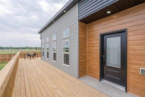 Mitchell apartment for rent - A modern house with a wooden deck and a black door.