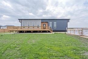 Mitchell apartment for rent - A modern house with a balcony overlooking a grassy area.