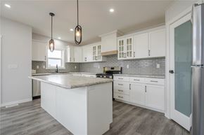 Mitchell apartment for rent - A kitchen with white cabinets and a marble countertop.