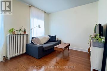 Toronto (Cabbagetown-South St. James Town) townhouse for rent - A living room with a blue couch and a wooden coffee table.