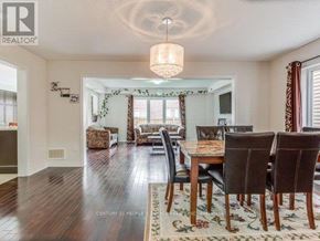 Brampton (Northwest Brampton) apartment for rent - A dining room with a wooden table and chairs.