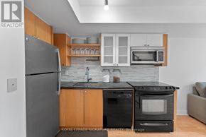 Toronto (Waterfront Communities) condo for rent - A kitchen with a refrigerator, oven, and microwave.
