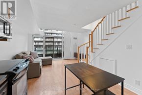 Toronto (Waterfront Communities) condo for rent - A modern living room with a staircase and a dining table.