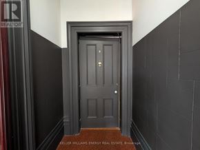 Prince Edward County (Picton Ward) fourplex for rent - A dark doorway with a brown doormat in front.