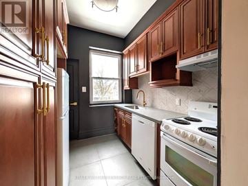 Prince Edward County (Picton Ward) fourplex for rent - A kitchen with a white stove top oven and a white dishwasher.