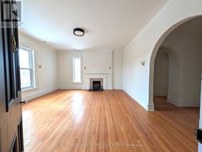 Prince Edward County (Picton Ward) fourplex for rent - A room with wooden floors and a fireplace.