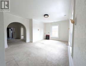 Prince Edward County (Picton Ward) fourplex for rent - A spacious room with a carpeted floor and white walls.