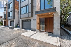 Ottawa apartment for rent - A modern two-story house with a wooden front door and garage.