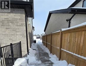 London apartment for rent - A snowy residential street with a REALTOR sign on the left.