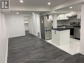 Ajax (South East) apartment for rent - A kitchen with a refrigerator, cabinets, and a countertop is shown in this image.