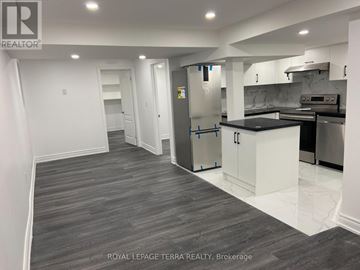 Ajax (South East) apartment for rent - A kitchen with a refrigerator, cabinets, and a countertop is shown in this image.