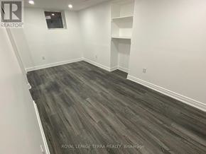 Ajax (South East) apartment for rent - A room with wooden flooring and white walls.