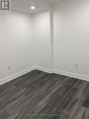 Ajax (South East) apartment for rent - A room with wooden flooring and white walls.