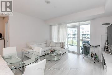 Innisfil condo for rent - A modern living room with a glass table and white furniture.
