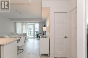 Innisfil condo for rent - A white interior of a house with a kitchen and living room.