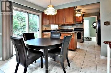 Newmarket (Central Newmarket) apartment for rent - A kitchen with a table and chairs in the middle of the room.
