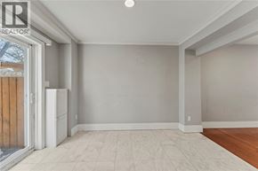 Windsor apartment for rent - A room with a white fridge and a sliding glass door.