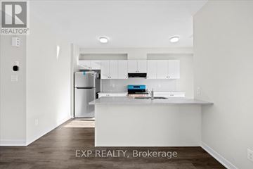Ottawa townhouse for rent - A kitchen with white cabinets and a countertop is shown in a real estate listing.