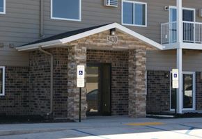 Moorhead apartment for rent - a brick building with a door and street signs