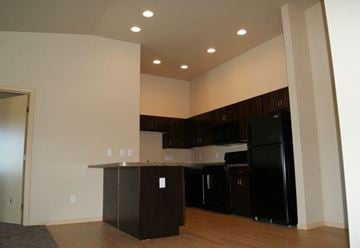 Moorhead apartment for rent - an empty kitchen with a counter and a refrigerator